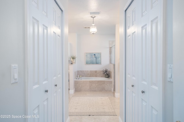 full bathroom with a stall shower, tile patterned floors, a closet, and a bath