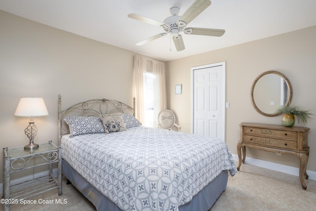 bedroom with a ceiling fan and baseboards