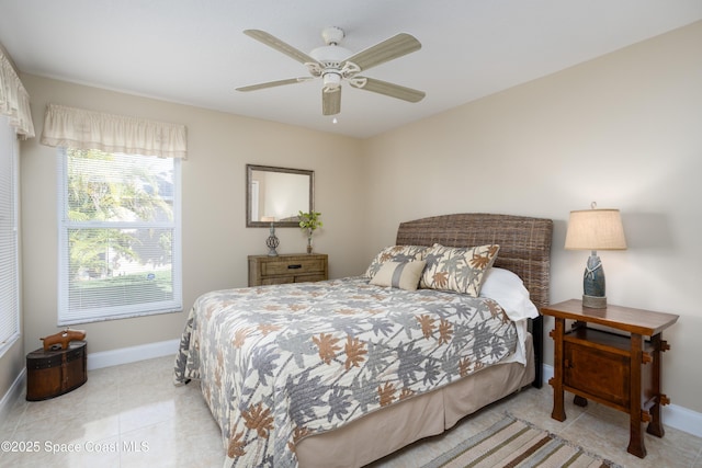 bedroom with a ceiling fan, light tile patterned flooring, and baseboards