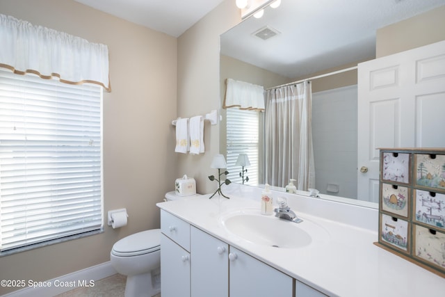 bathroom featuring baseboards, visible vents, toilet, a shower with curtain, and vanity