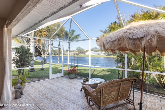 sunroom / solarium featuring a water view