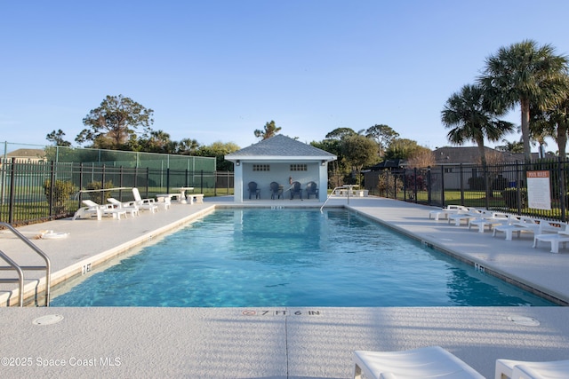 pool featuring a patio area and fence