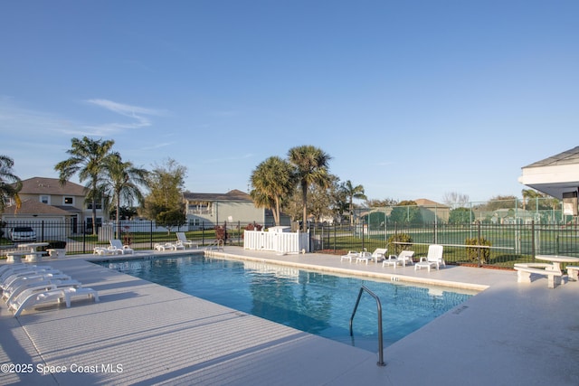 pool featuring a patio area and fence