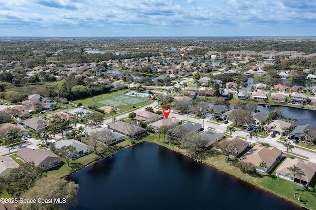 drone / aerial view featuring a water view and a residential view