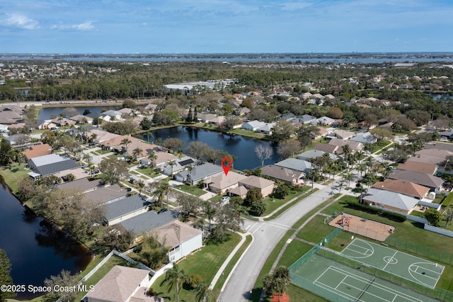 drone / aerial view with a water view and a residential view