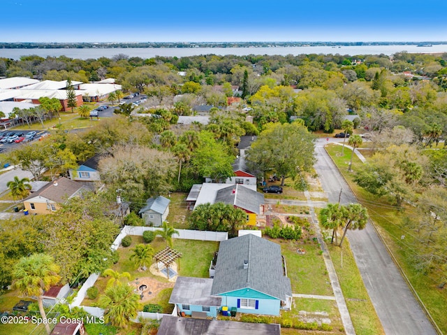 drone / aerial view featuring a water view and a residential view