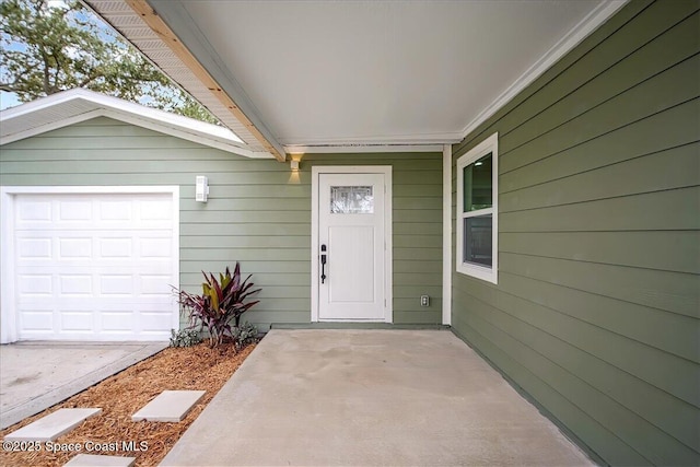 view of exterior entry with a garage