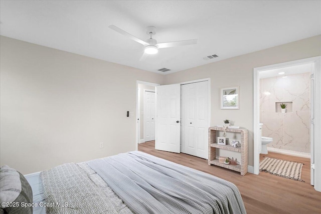 bedroom with a ceiling fan, a closet, visible vents, and wood finished floors