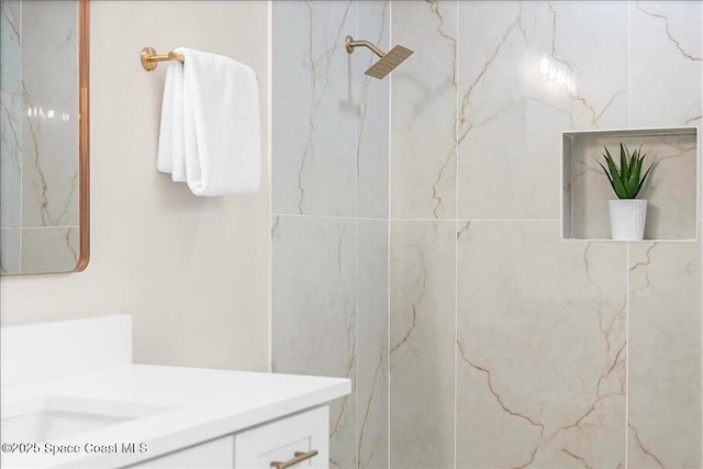 full bathroom with vanity and a marble finish shower