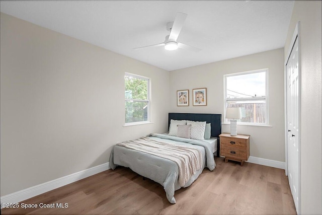 bedroom featuring light wood-type flooring, ceiling fan, and baseboards