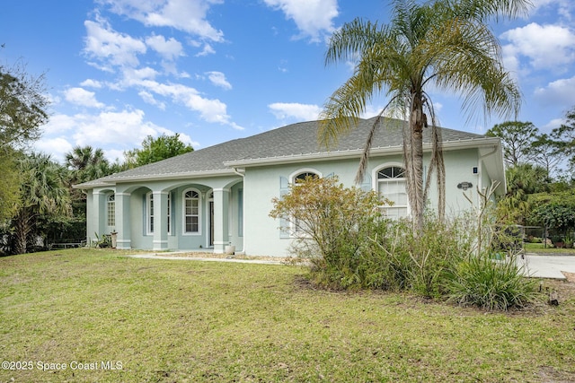 single story home featuring a front yard and stucco siding