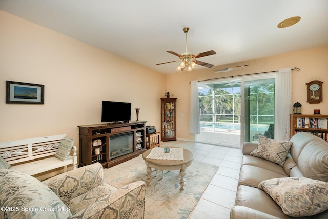 living room featuring lofted ceiling, a sunroom, tile patterned flooring, and a ceiling fan