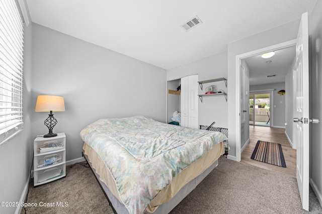 bedroom featuring carpet floors, a closet, visible vents, and baseboards