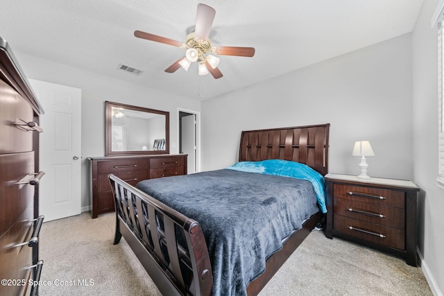 bedroom with baseboards, a ceiling fan, visible vents, and light colored carpet