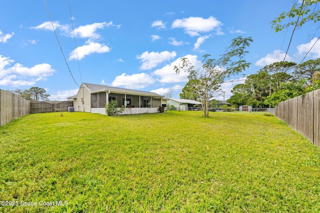 view of yard with a fenced backyard and a sunroom