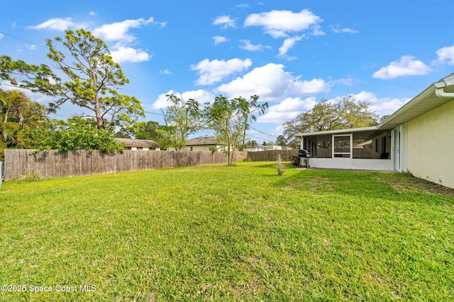 view of yard featuring a sunroom and fence