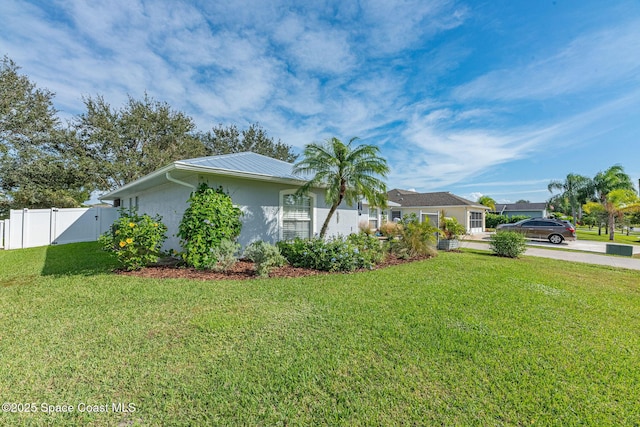 view of front facade featuring a front lawn, fence, a gate, and stucco siding