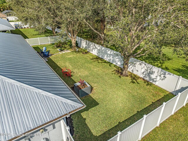 view of yard featuring central AC unit and a fenced backyard