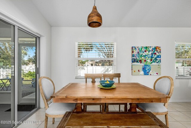 dining area with light tile patterned floors and baseboards