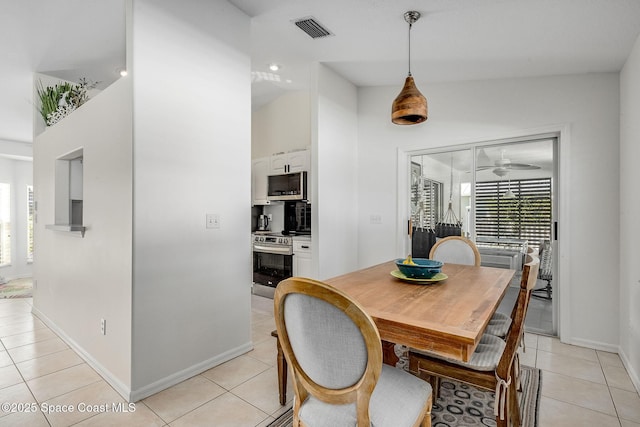 dining area with light tile patterned flooring, visible vents, and baseboards