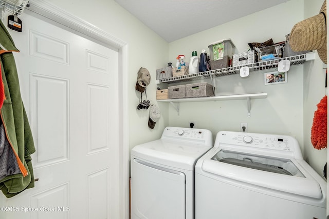 washroom with washing machine and dryer and laundry area