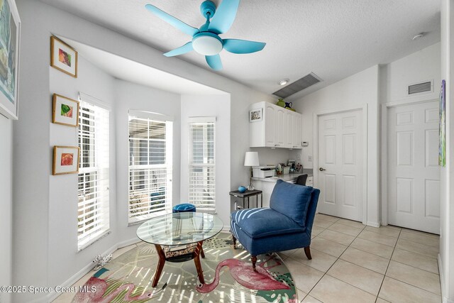 sitting room with visible vents, light tile patterned flooring, and a wealth of natural light