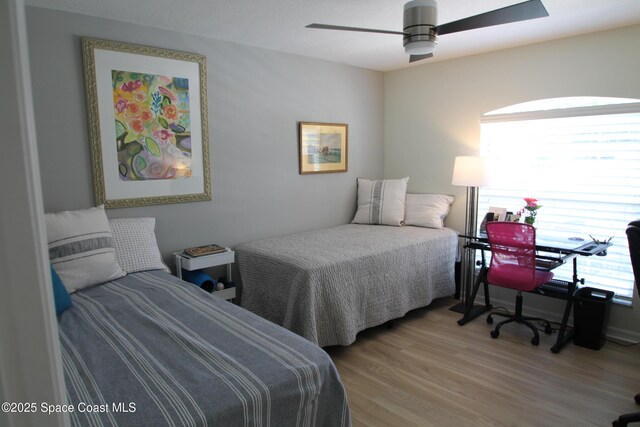 bedroom with a ceiling fan and wood finished floors