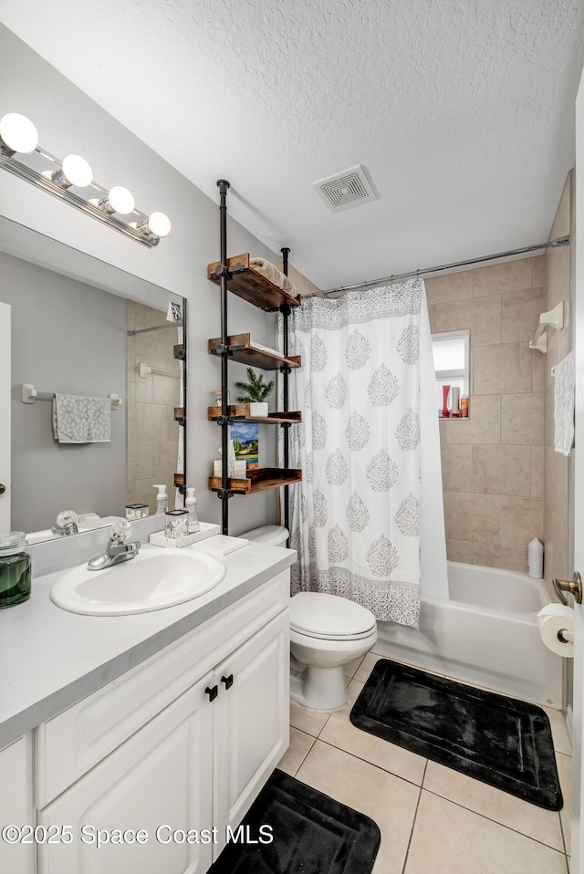 bathroom featuring visible vents, tile patterned floors, shower / bath combo with shower curtain, a textured ceiling, and vanity