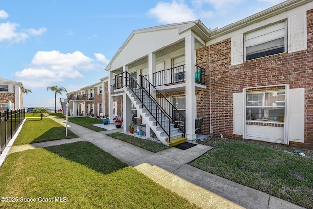 view of property's community featuring stairway and a yard