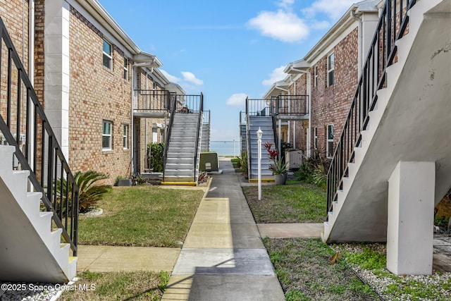 view of community with stairs and a lawn