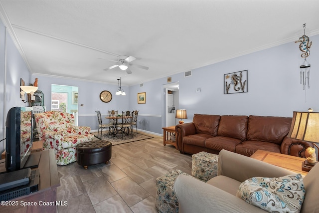 living area with baseboards, visible vents, a ceiling fan, and crown molding