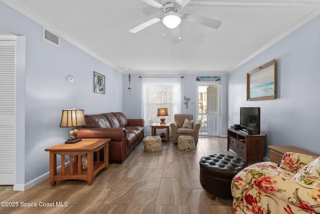 living room with baseboards, visible vents, ceiling fan, and ornamental molding