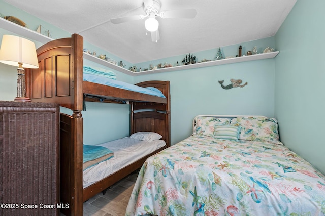 bedroom featuring a ceiling fan, a textured ceiling, and wood finished floors