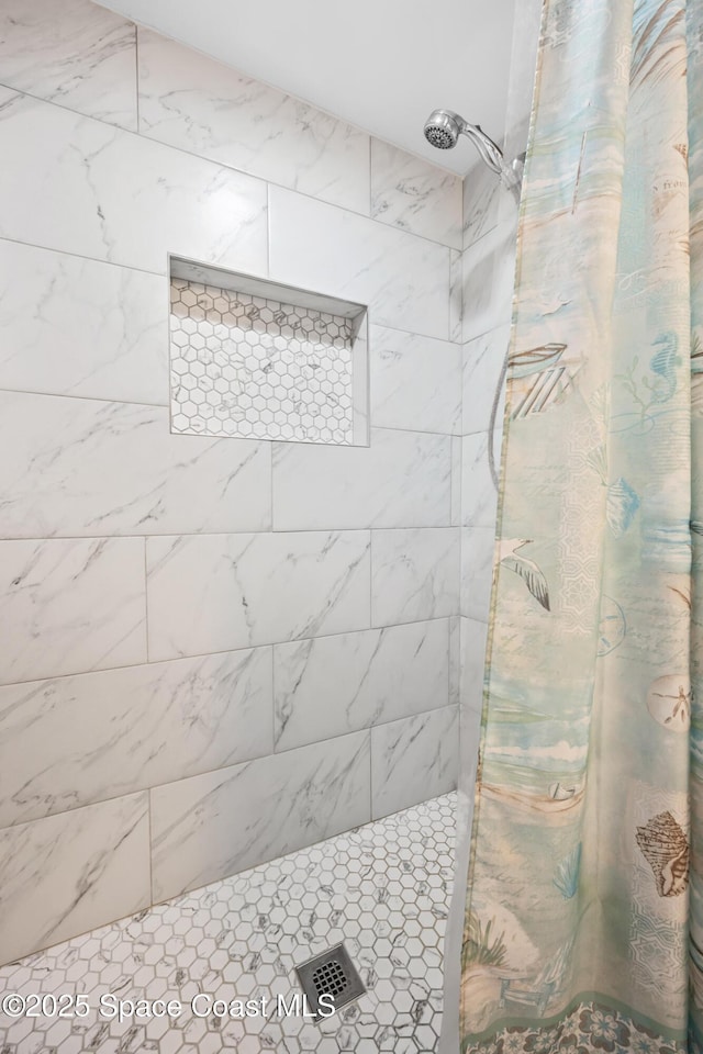 bathroom with tiled shower