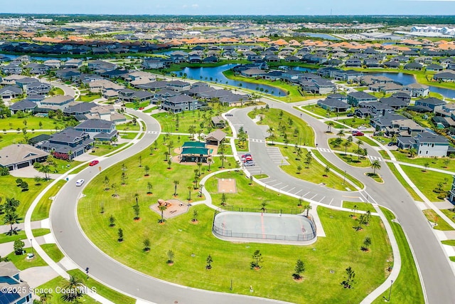 drone / aerial view featuring a residential view and a water view