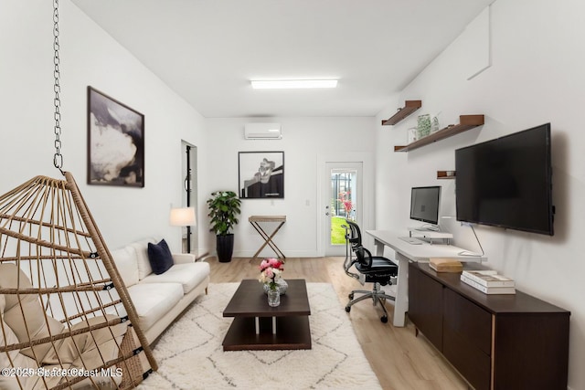 home office with light wood-type flooring and a wall mounted air conditioner