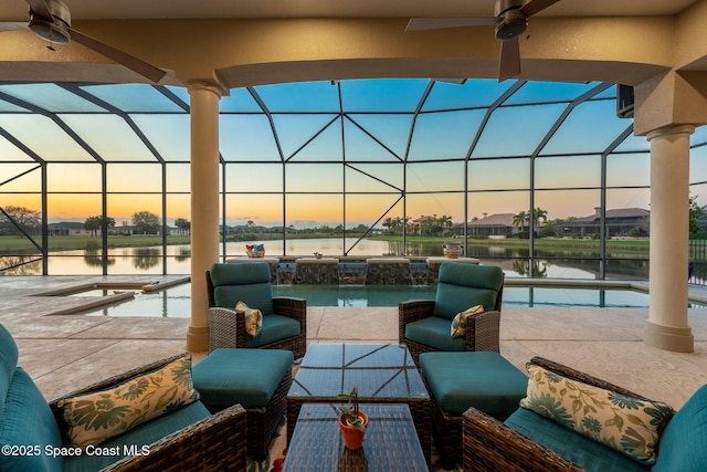 view of patio featuring glass enclosure, ceiling fan, and an outdoor living space