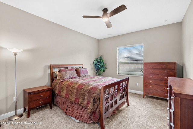 bedroom with light carpet, baseboards, and a ceiling fan