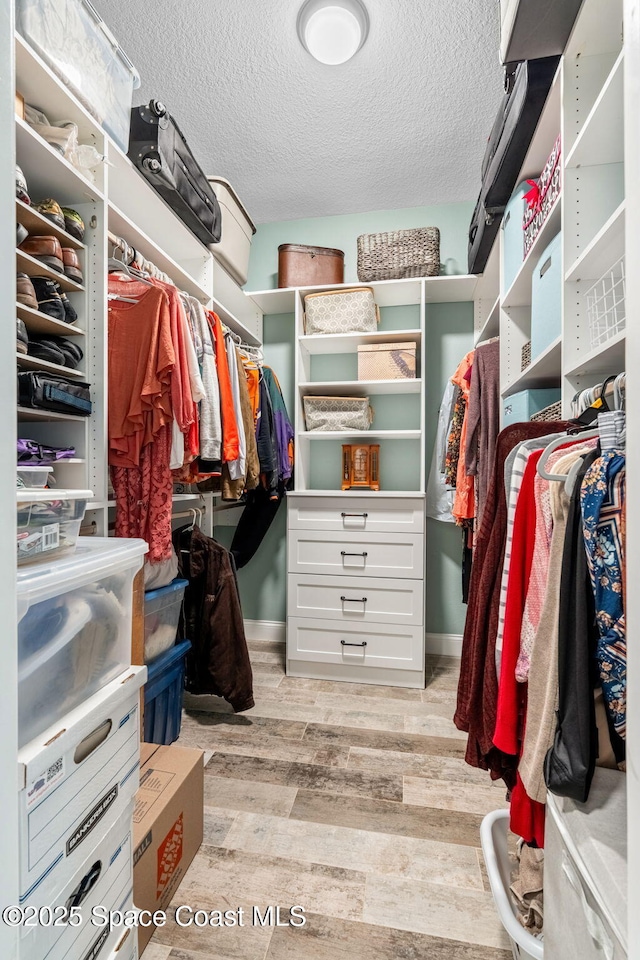 spacious closet with light wood-style floors