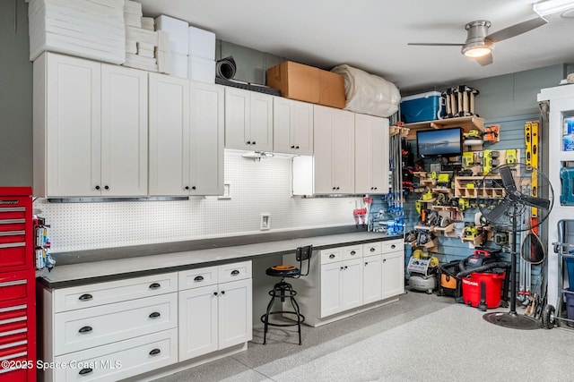 garage featuring ceiling fan and a workshop area