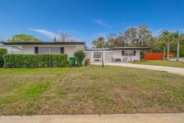 ranch-style home with a front yard, fence, and stucco siding