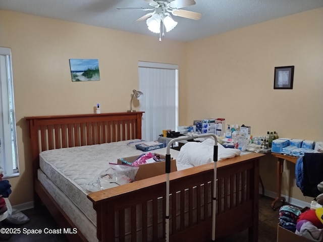 bedroom featuring a ceiling fan and baseboards