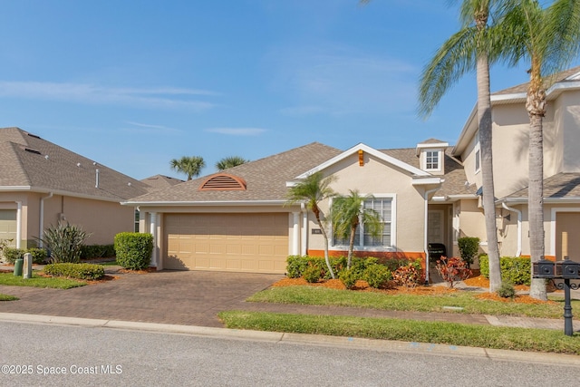 view of front of home with a garage, a shingled roof, decorative driveway, and stucco siding