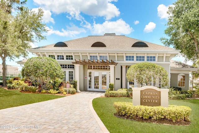 view of building exterior with decorative driveway