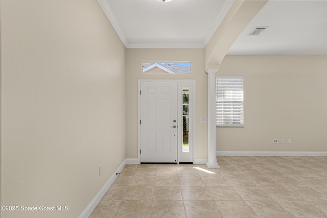 foyer entrance with crown molding, visible vents, decorative columns, and baseboards