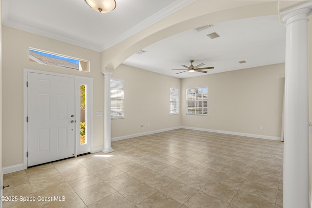 entrance foyer with arched walkways, a ceiling fan, baseboards, ornate columns, and crown molding