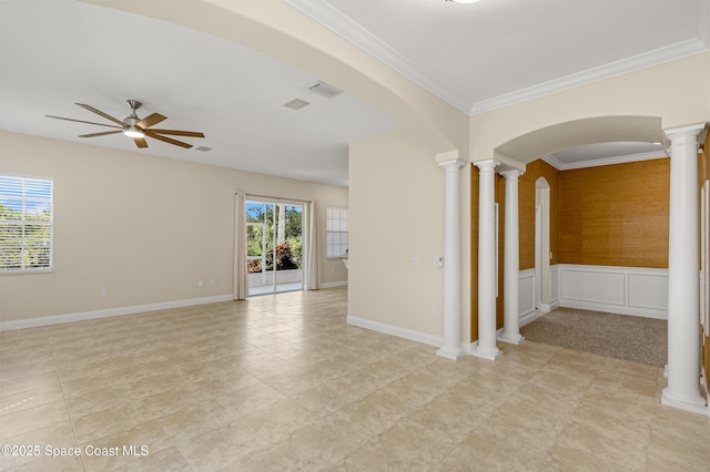 unfurnished room with decorative columns, visible vents, arched walkways, a ceiling fan, and crown molding