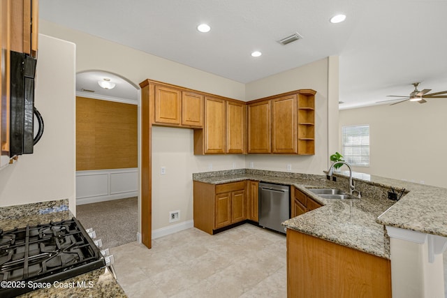 kitchen featuring dishwasher, a peninsula, light stone countertops, open shelves, and a sink