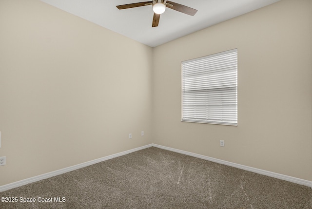 unfurnished room featuring a ceiling fan, carpet flooring, and baseboards