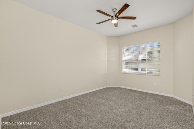 spare room featuring baseboards, visible vents, a ceiling fan, and carpet flooring